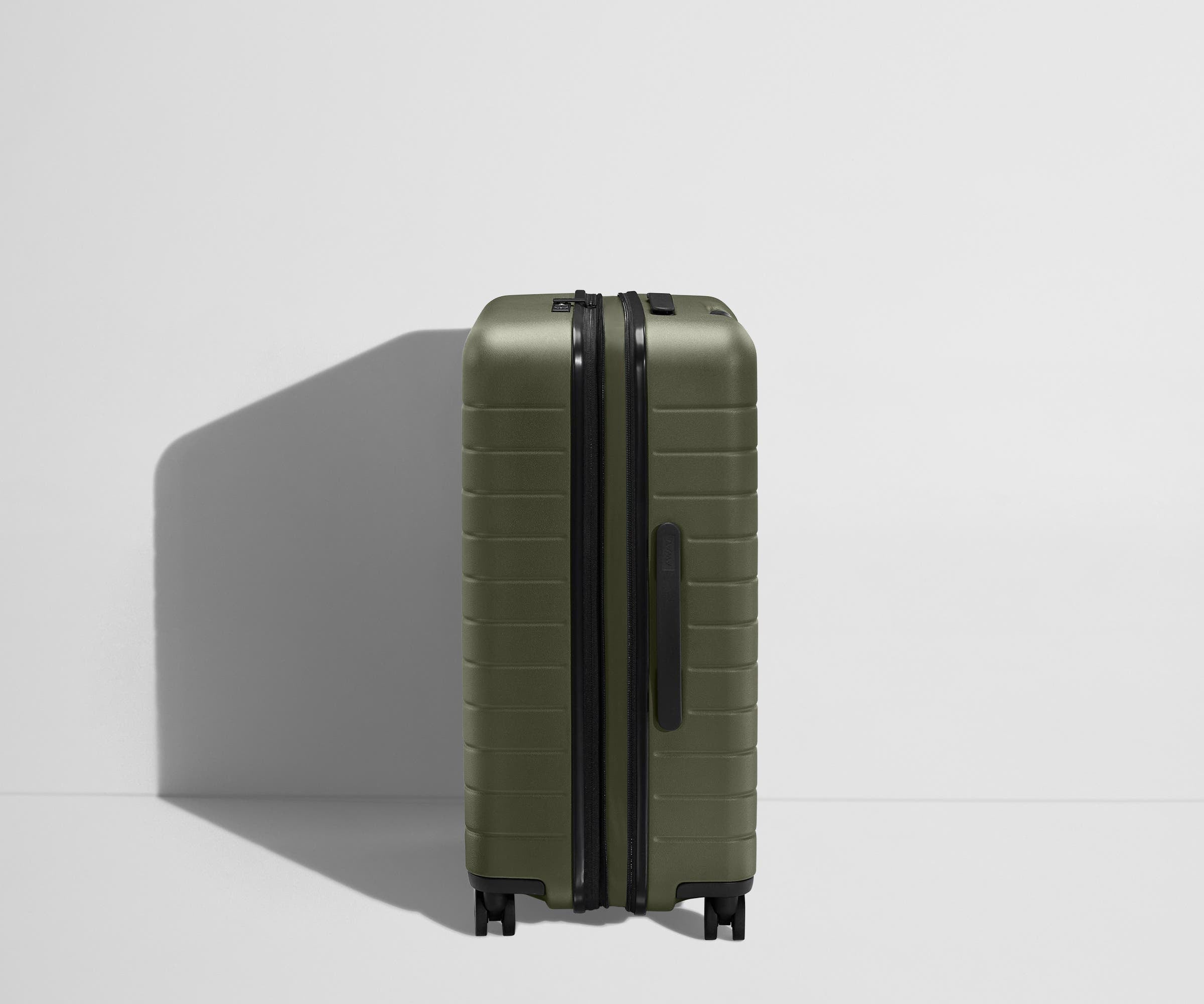 Side product view of The Medium Flex suitcase in Sea Green shown fully expanded