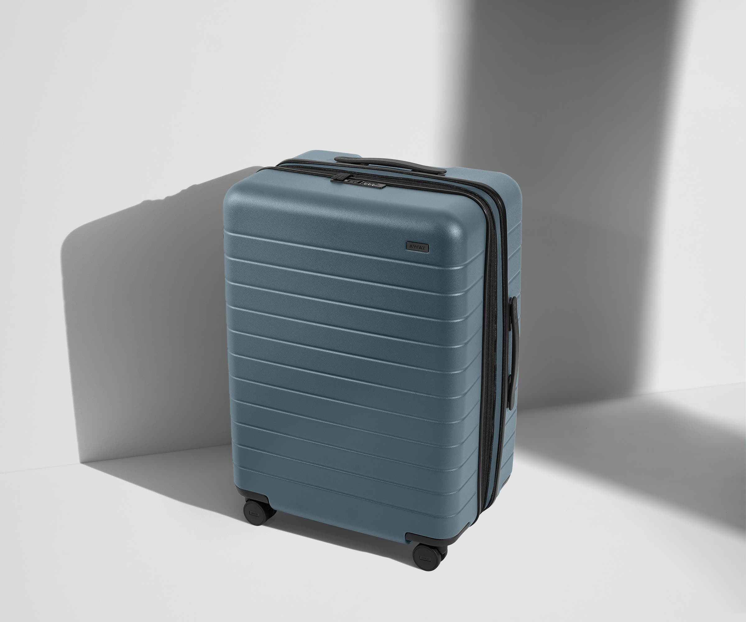 Angled product view of The Medium Flex suitcase in Coast Blue