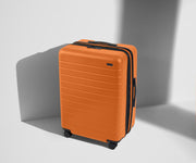 Angled product view of The Medium Flex suitcase in Sorbet Orange