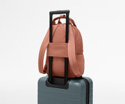 Featherlight Backpack on top of an Away suitcase, attached by the trolley sleeve
