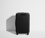 Back product view of The Bigger Carry-On suitcase in Jet Black