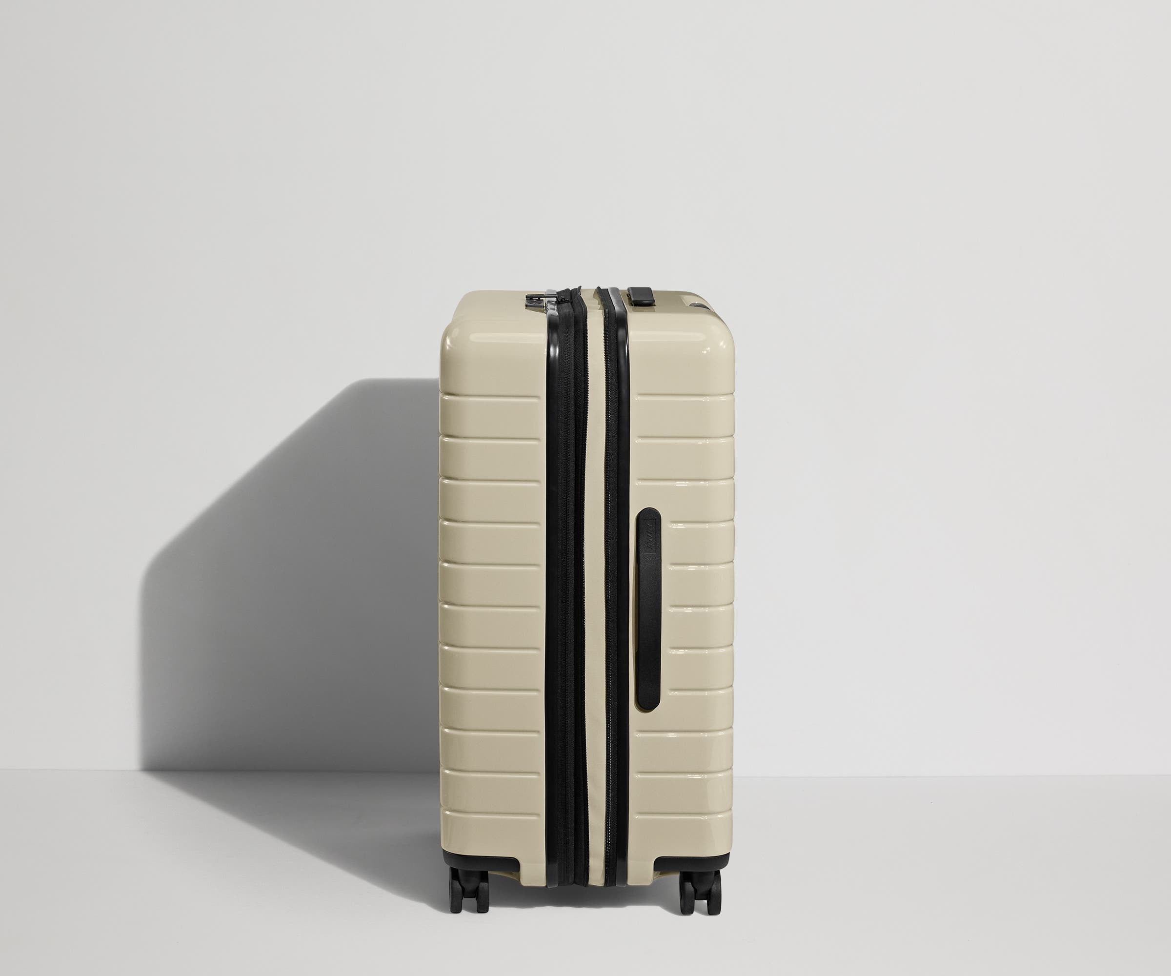 Side product view of The Medium Flex suitcase in Salt White (Gloss) shown fully expanded