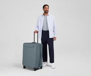 Person standing next to the Softside Large for scale