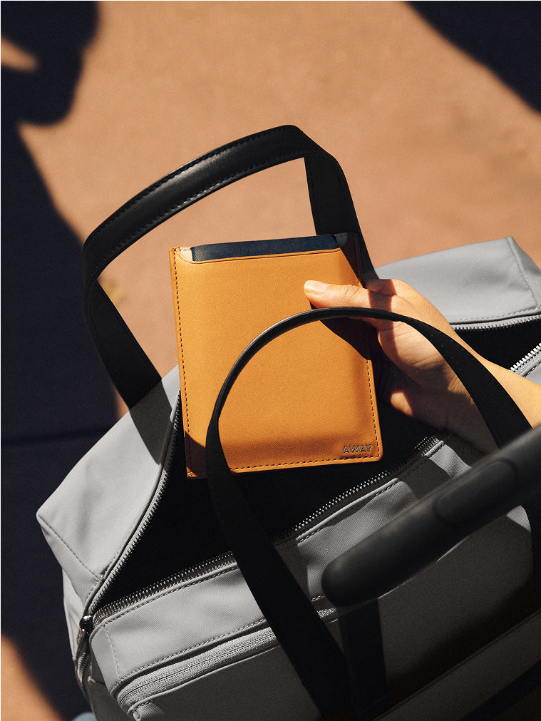 Leather passport holder packed into an Away®75秒极速赛车官方网站 duffle bag