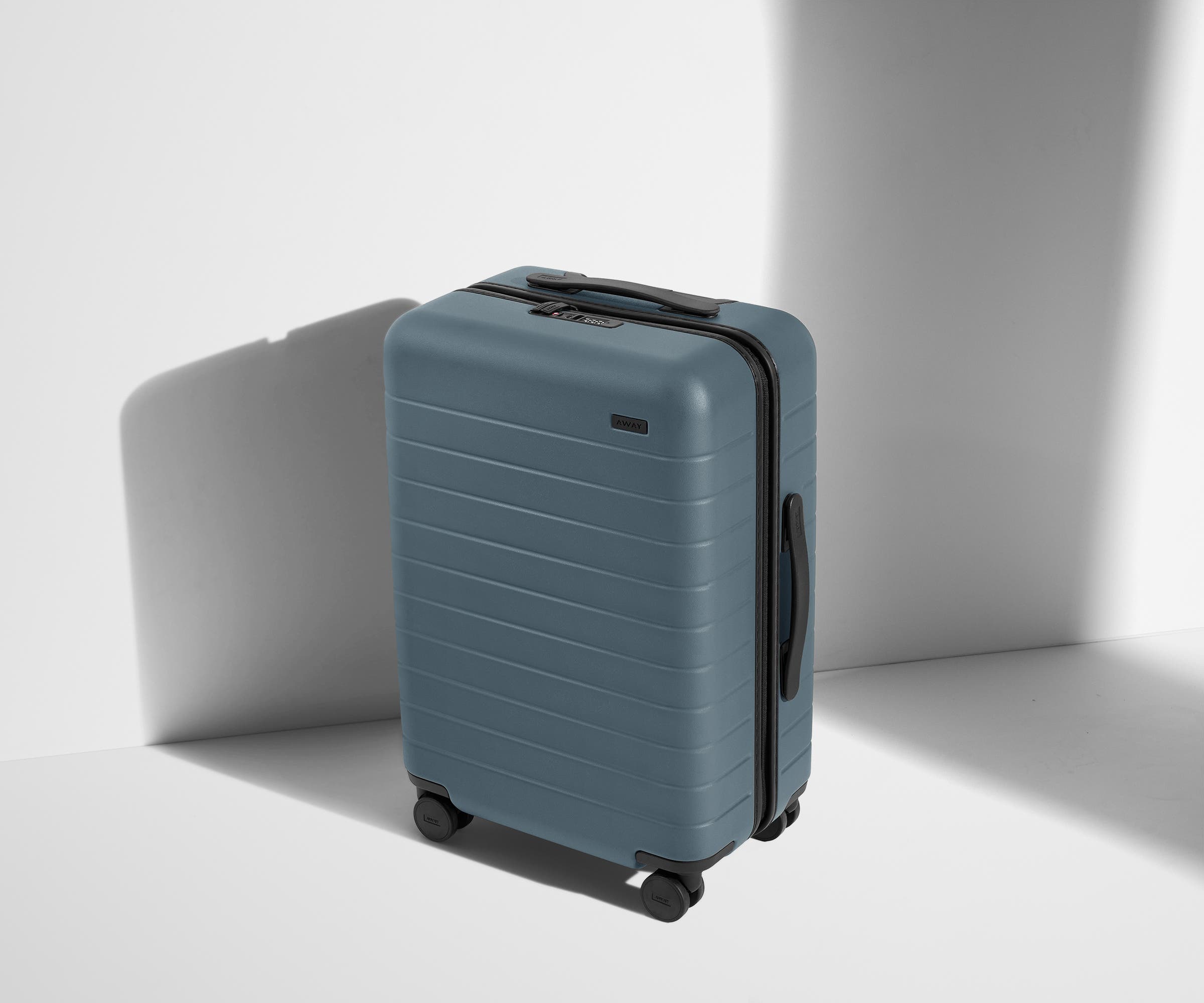 Angled product view of The Bigger Carry-On suitcase in Coast Blue