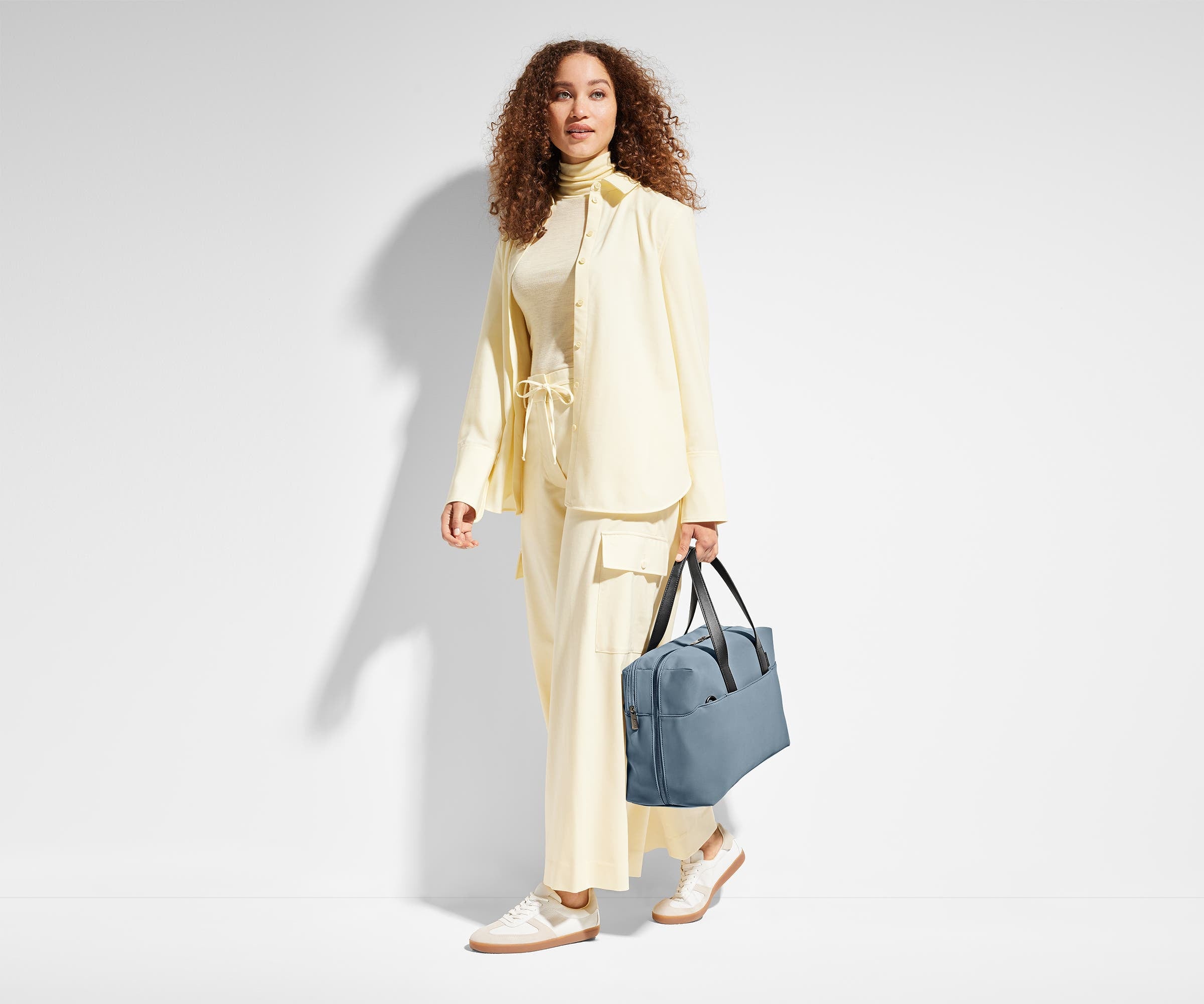 Person holding the Everywhere Bag by its leather straps