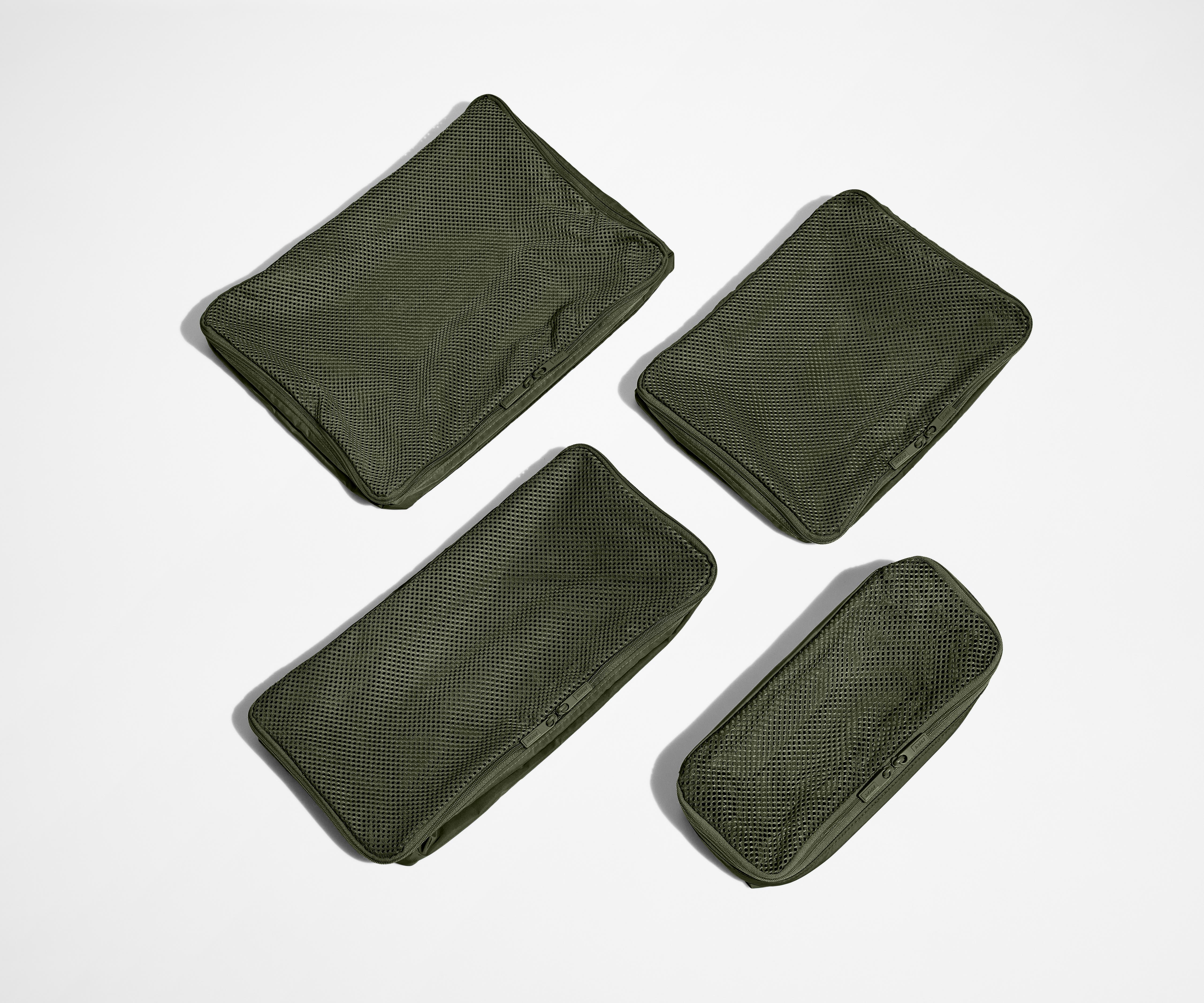 Set of four unpacked Packing Cubes laying flat