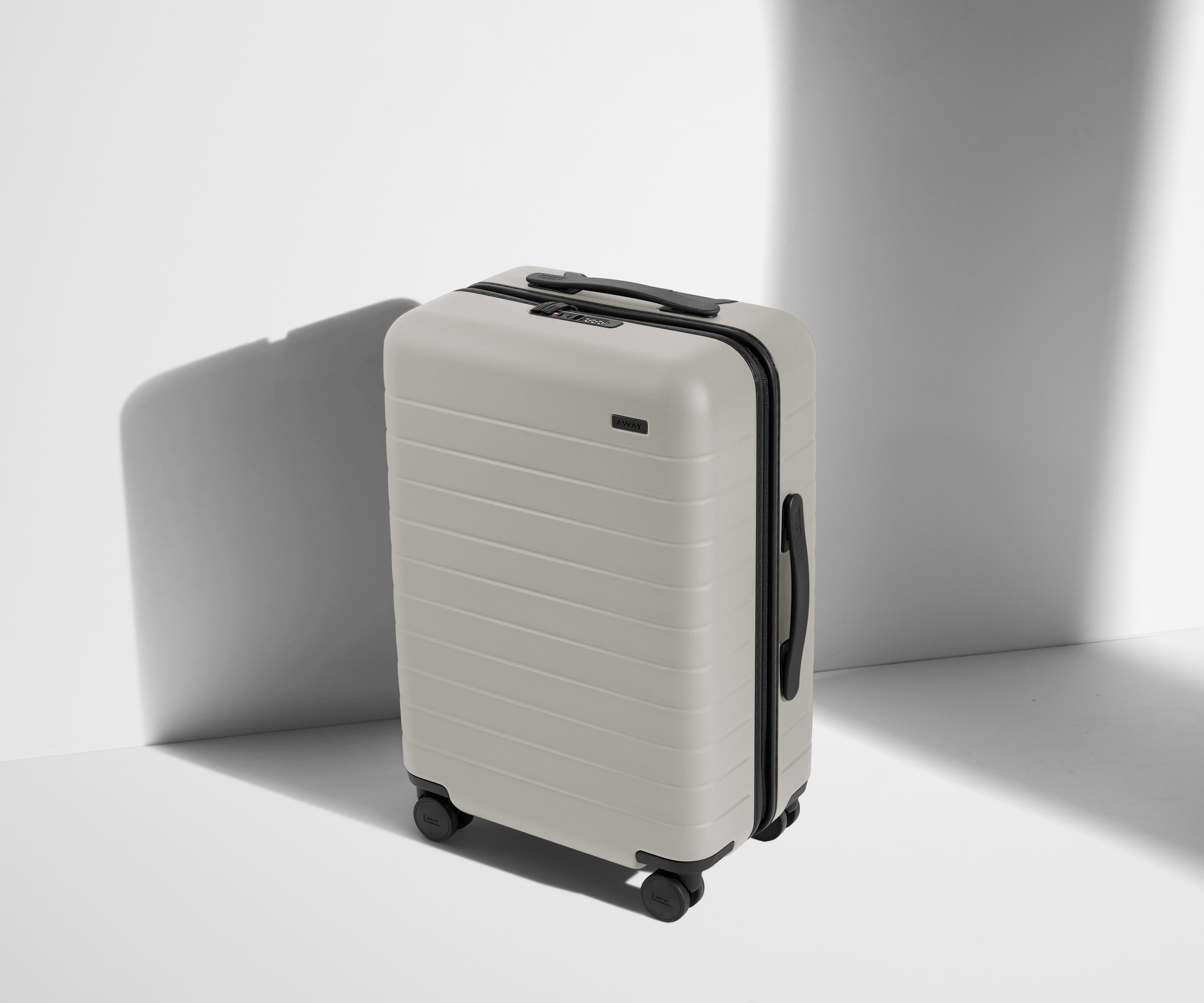 Angled product view of The Bigger Carry-On suitcase in Cloud Gray
