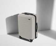 Angled product view of The Bigger Carry-On suitcase in Cloud Gray