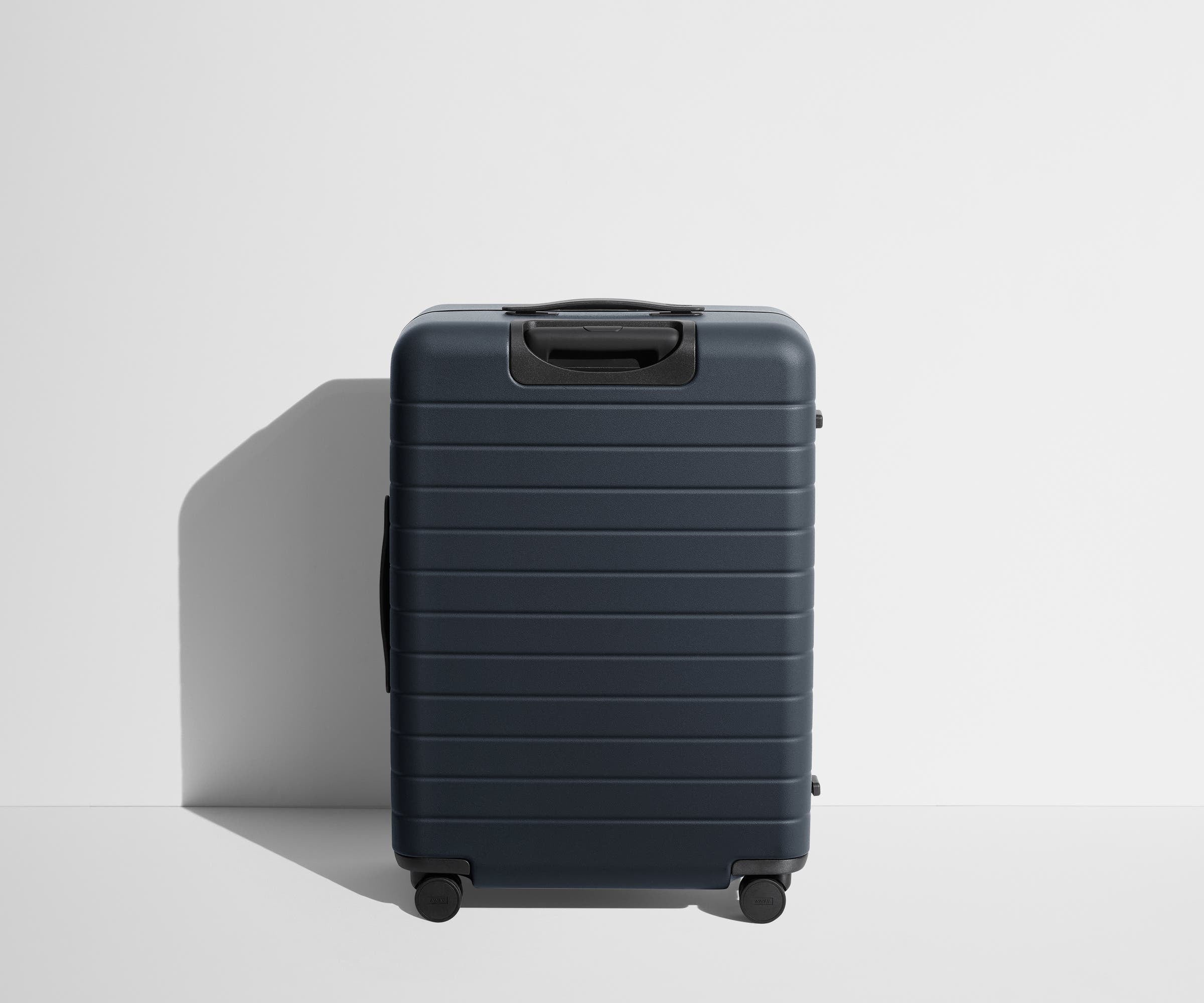 Back product view of The Medium Flex suitcase in Navy Blue