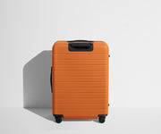 Back product view of The Medium Flex suitcase in Sorbet Orange