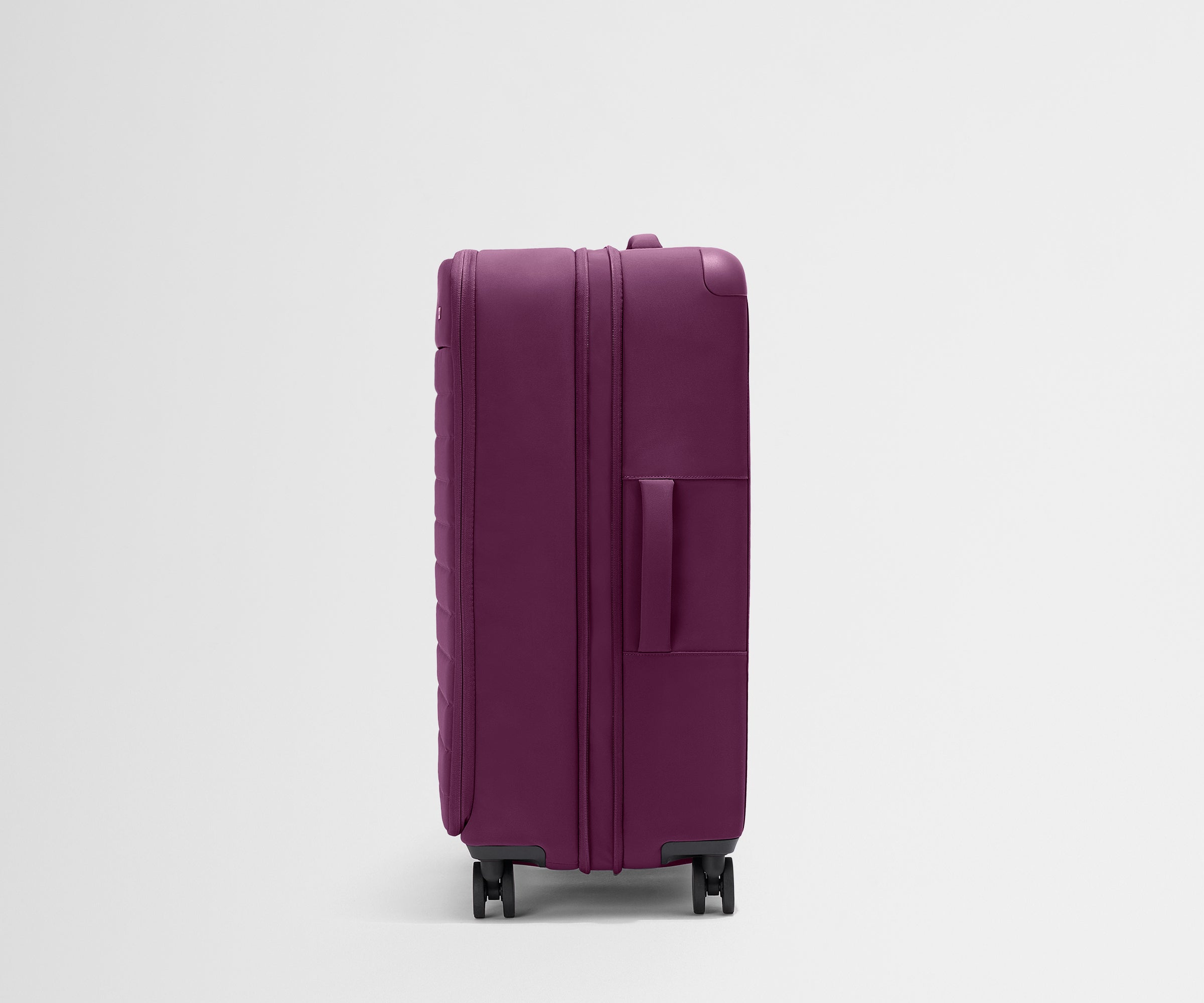 Side product view of The Softside Large suitcase in Plum Purple shown fully expanded